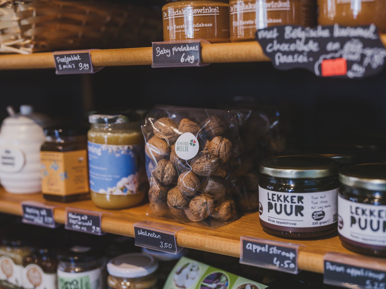 services-03 Explore a vibrant Dutch store in Almere featuring local food items like walnuts, honey, and jams.